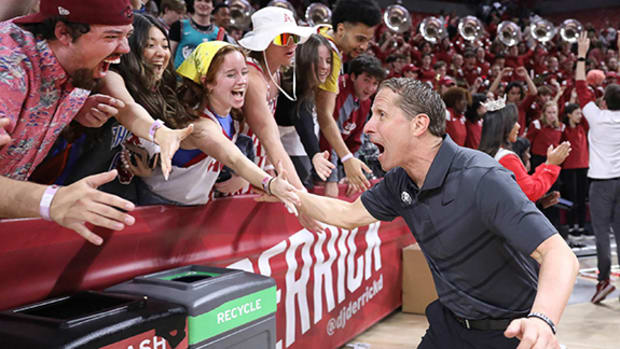 Arkansas Razorbacks coach Eric Musselman with fans after a game with the Georgia Bulldogs.